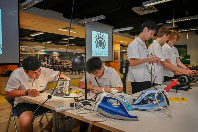 Students working on assembling electrical appliances